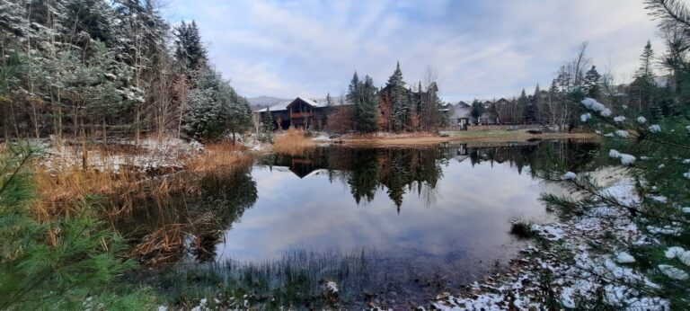 Scenic view of Whiteface Lodge over a crisp, frosty lake